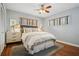 Cozy bedroom with hardwood floors, ceiling fan, and natural light from two large windows at 2711 Winding Ne Ln, Brookhaven, GA 30319