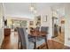 Open dining area with hardwood floors, modern furnishings, and a view into the living room at 2711 Winding Ne Ln, Brookhaven, GA 30319