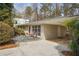 Exterior showing a single-story home featuring a carport and landscaped front yard at 2711 Winding Ne Ln, Brookhaven, GA 30319