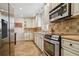 Charming kitchen featuring stainless steel appliances, custom cabinets, and tile backsplash at 2711 Winding Ne Ln, Brookhaven, GA 30319