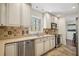 Well-lit kitchen featuring stainless steel appliances, tile backsplash, and hardwood flooring at 2711 Winding Ne Ln, Brookhaven, GA 30319