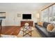 Bright living room showcasing hardwood floors, a large window, and comfortable seating at 2711 Winding Ne Ln, Brookhaven, GA 30319