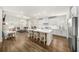 Open-concept kitchen with white cabinets, a large center island, and seamless flow into the living room at 2917 Knob Creek Dr, Snellville, GA 30078