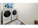 Laundry room with stacked washer and dryer and light blue accent rug at 2917 Knob Creek Dr, Snellville, GA 30078