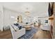 Open-concept living room with fireplace flows into kitchen with white cabinets and hardwood floors at 2917 Knob Creek Dr, Snellville, GA 30078