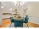 Charming dining area adjacent to kitchen, featuring modern lighting and seating for four, great for dining at 6105 Queen Anne Ct, Norcross, GA 30093