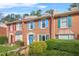 Beautiful brick townhome featuring vibrant shutters and manicured landscaping at 6105 Queen Anne Ct, Norcross, GA 30093