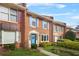 Attractive brick townhome with colorful shutters and a well-kept lawn at 6105 Queen Anne Ct, Norcross, GA 30093