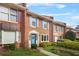 Brick townhome with colorful shutters, bright blue door with wreath, and a well-maintained front yard at 6105 Queen Anne Ct, Norcross, GA 30093