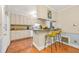 Functional kitchen bar with granite counters, seating, and ample cabinet space that connects to dining room at 6105 Queen Anne Ct, Norcross, GA 30093