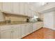 Traditional style kitchen with beige cabinets, granite countertops, tile backsplash, and stainless steel appliances at 6105 Queen Anne Ct, Norcross, GA 30093