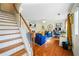 Bright, open-concept living room with hardwood floors, modern furniture, and a staircase at 6105 Queen Anne Ct, Norcross, GA 30093