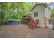 View of backyard featuring a wooden deck with stairs and a partially covered structure at 31 Greenland Trce, Atlanta, GA 30342
