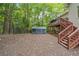 Fenced backyard featuring an outdoor tent, trees, and a deck with stairs at 31 Greenland Trce, Atlanta, GA 30342