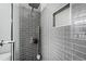 Shower detail in a modern bathroom with gray subway tile, built-in niche, and modern fixtures at 31 Greenland Trce, Atlanta, GA 30342