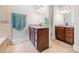 Bathroom with dual vanities, granite countertops, tile flooring, and a soaking tub at 31 Greenland Trce, Atlanta, GA 30342