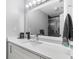 Modern bathroom with large mirror, quartz countertops and a gray tile shower at 31 Greenland Trce, Atlanta, GA 30342