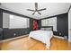 A bedroom with hardwood floors, natural light, and a modern ceiling fan creates a comfortable, inviting space at 31 Greenland Trce, Atlanta, GA 30342