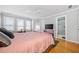 Bedroom with hardwood floors featuring a closet and door leading to a bathroom at 31 Greenland Trce, Atlanta, GA 30342