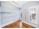 Walk-in closet with custom shelving, hardwood floors, and two windows providing natural light at 31 Greenland Trce, Atlanta, GA 30342