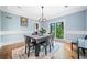 A bright dining room with hardwood floors, wainscoting, and natural light from a large window at 31 Greenland Trce, Atlanta, GA 30342