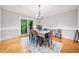 Formal dining room with hardwood floors, elegant chandelier, and large window with natural light at 31 Greenland Trce, Atlanta, GA 30342