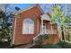 Charming brick home with a quaint front porch and mature trees at 31 Greenland Trce, Atlanta, GA 30342
