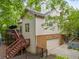 Exterior view of home featuring a deck, an outdoor staircase, and a single car garage at 31 Greenland Trce, Atlanta, GA 30342