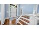 Bright foyer with hardwood floors, a staircase, and a front door flanked by sidelight windows at 31 Greenland Trce, Atlanta, GA 30342