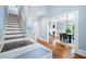 Open foyer with hardwood floors, a staircase, and a view into a formal dining room with wainscoting at 31 Greenland Trce, Atlanta, GA 30342