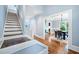 The foyer has a stairway and entrance to the dining room with hardwood floors and light-blue walls at 31 Greenland Trce, Atlanta, GA 30342