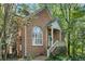 Charming brick home with a cozy front porch and well-maintained landscaping surrounded by mature trees at 31 Greenland Trce, Atlanta, GA 30342