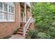 Inviting front porch with brick stairs and white railings, perfect for relaxing outdoors at 31 Greenland Trce, Atlanta, GA 30342