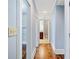Hallway with hardwood floors that provides access to closets and a bathroom at 31 Greenland Trce, Atlanta, GA 30342
