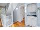Bright hallway with hardwood floors, stairs, and a built-in sink at 31 Greenland Trce, Atlanta, GA 30342