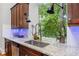 Bright kitchen sink with granite countertops and a view to the wooded outdoors at 31 Greenland Trce, Atlanta, GA 30342