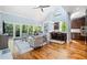 An open-concept living room with a vaulted ceiling, hardwood floors, and a connection to the kitchen at 31 Greenland Trce, Atlanta, GA 30342