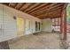 Under-deck brick patio with access door and windows provides a cool, shaded outdoor living space at 31 Greenland Trce, Atlanta, GA 30342