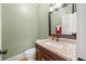 Stylish powder room features a granite countertop and classic fixtures at 31 Greenland Trce, Atlanta, GA 30342
