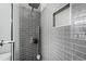 Sleek walk-in shower with gray subway tile and a built-in niche for storage at 31 Greenland Trce, Atlanta, GA 30342