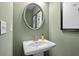 Powder room with pedestal sink, decorative mirror, and neutral paint at 315 Skye Ln # 50, Cartersville, GA 30121