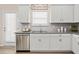 Bright and modern kitchen with a stainless steel dishwasher and white cabinets at 315 Skye Ln # 50, Cartersville, GA 30121