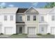 Charming townhome featuring a modern facade, private garage, and beautifully landscaped front yard at 44 Alameda St # 130, Loganville, GA 30052