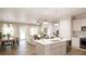 Open concept living space with a kitchen, dining area and living room featuring a modern fireplace at 44 Alameda St # 130, Loganville, GA 30052