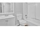 Bathroom features a vanity, toilet and shower-tub combo with white tile surround at 5338 Timor Trl, Lithonia, GA 30038