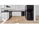 Modern kitchen with white cabinetry, black appliances, and a neutral tile floor at 5338 Timor Trl, Lithonia, GA 30038