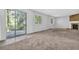 A living room with a brick fireplace, a sliding glass door and carpet floors at 5338 Timor Trl, Lithonia, GA 30038