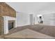 A living room with a brick fireplace and carpet floors at 5338 Timor Trl, Lithonia, GA 30038