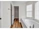 Bright bathroom featuring vinyl floors, soaking tub with windows, and a separate shower at 114 Belmonte Sw Dr, Atlanta, GA 30311