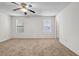 Large bedroom with a ceiling fan, two windows, neutral carpet, and access to a closet at 114 Belmonte Sw Dr, Atlanta, GA 30311